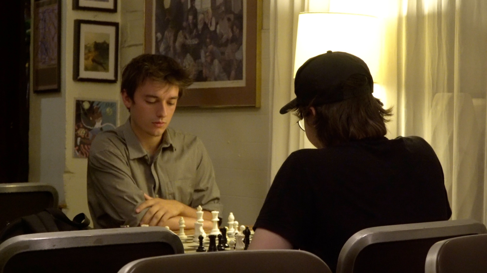 Two players sit across a chessboard at Chess Forum in New York.