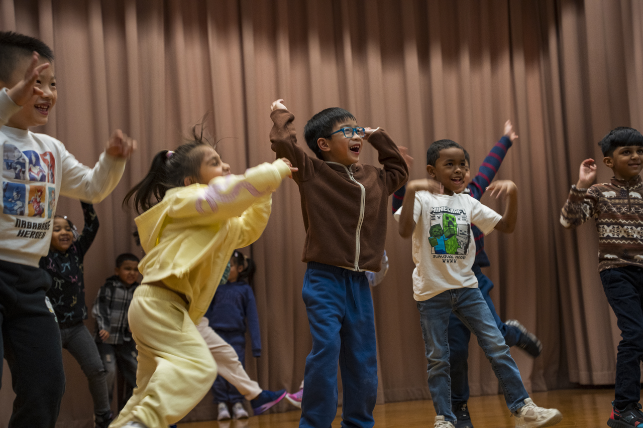 Students repeat the sequence as they cross the stage.