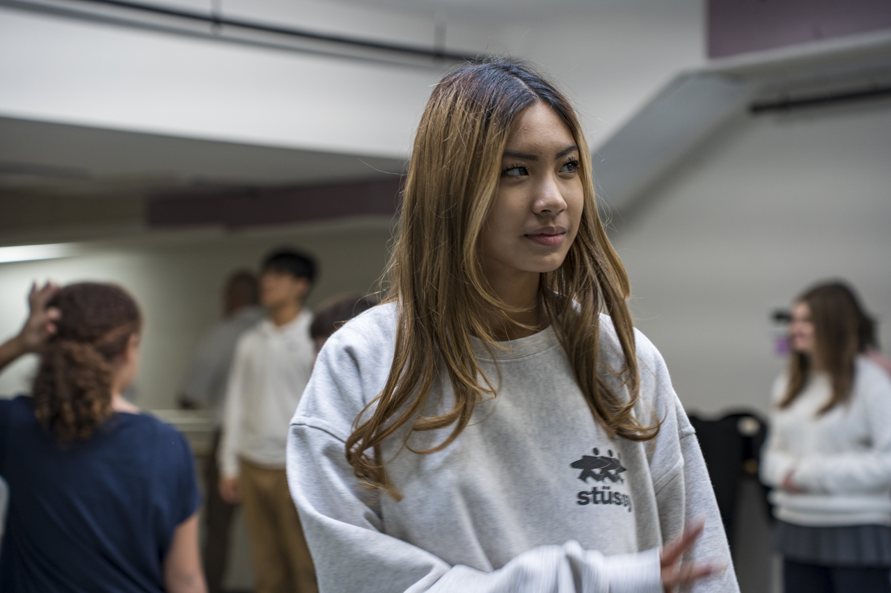 A student pauses near the mirror between exercises.