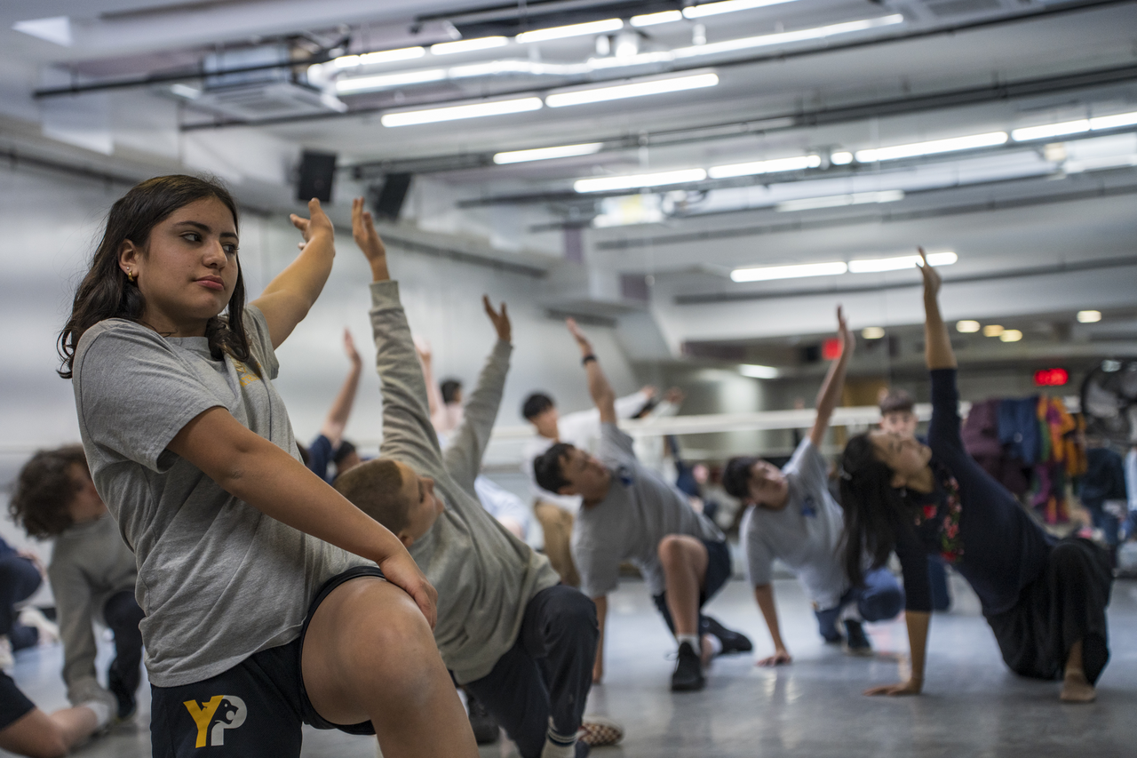 Children raise their arms during a Chinese dance class in Manhattan.