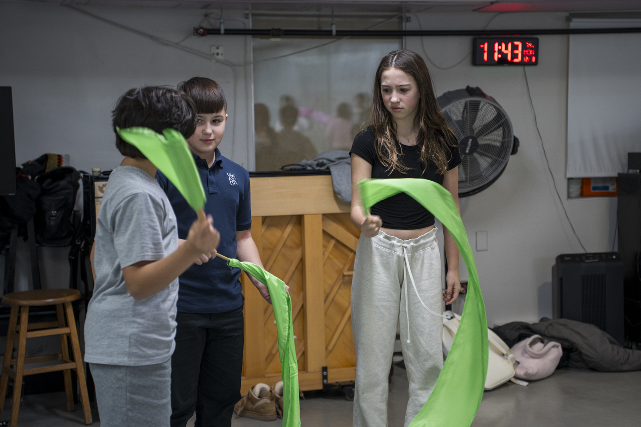 Students practice with green ribbons.