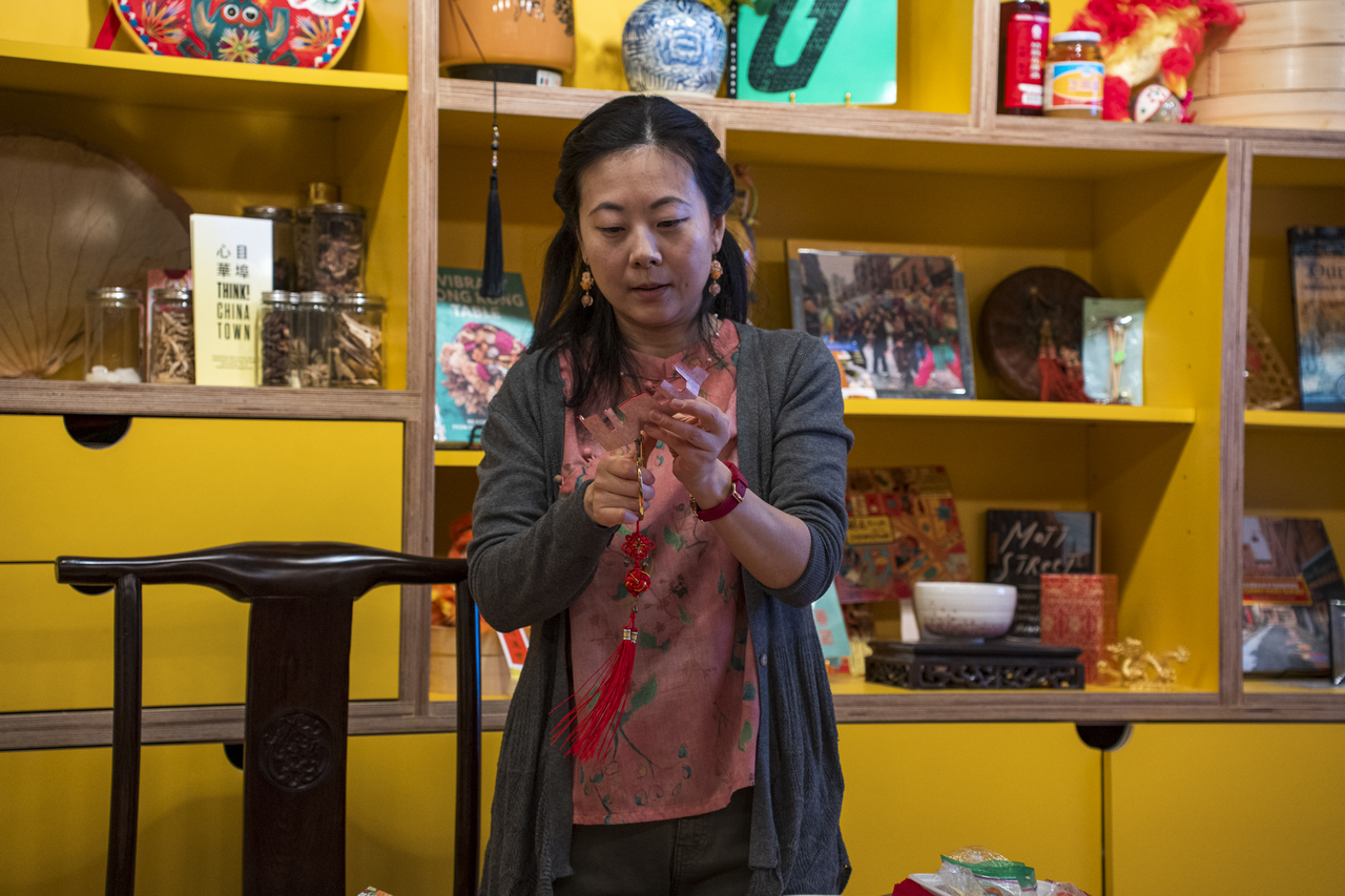 At a paper-cutting workshop, Tang demonstrates each step.