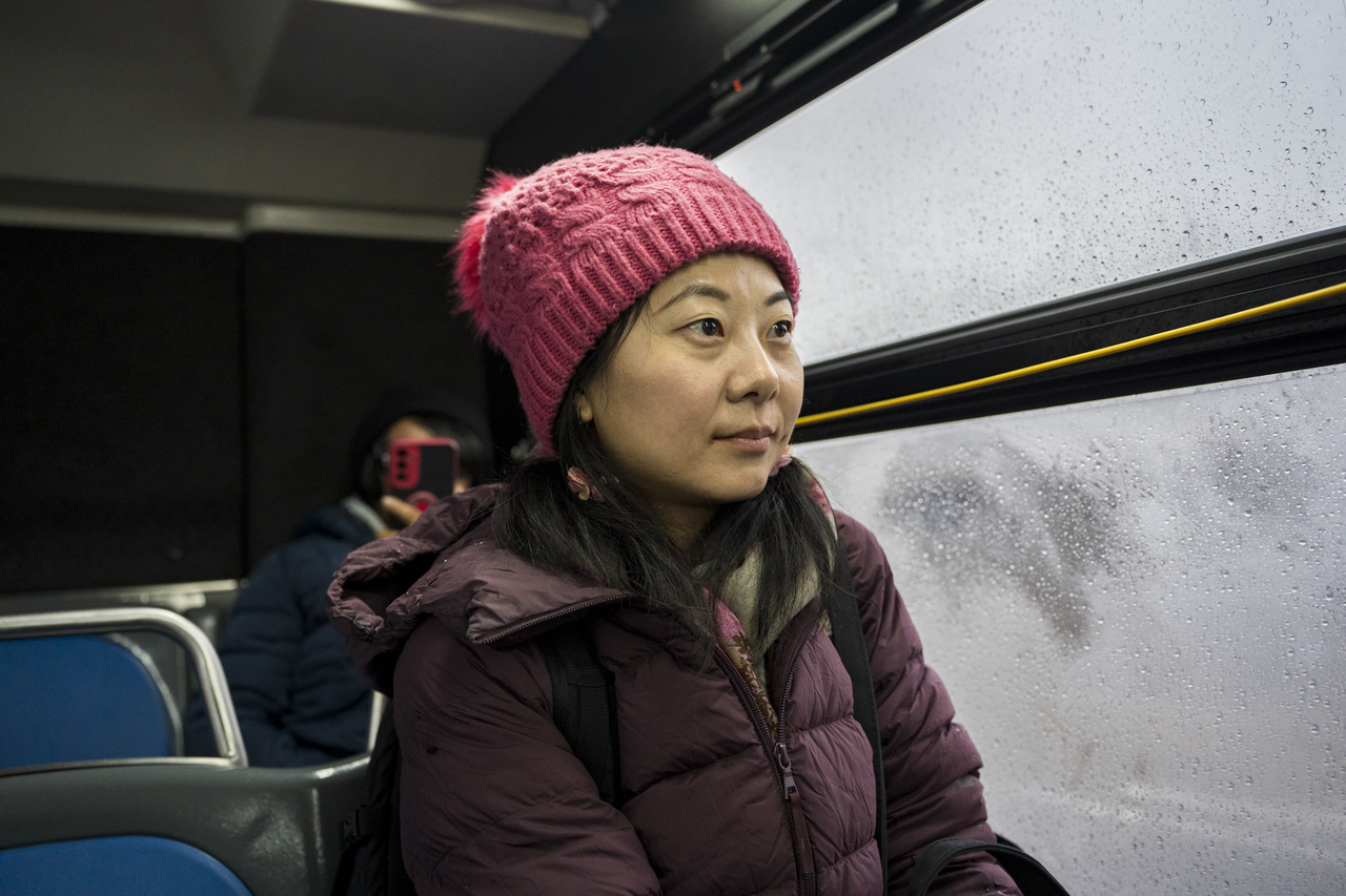 Tang rides the bus home through a rainy Queens afternoon.