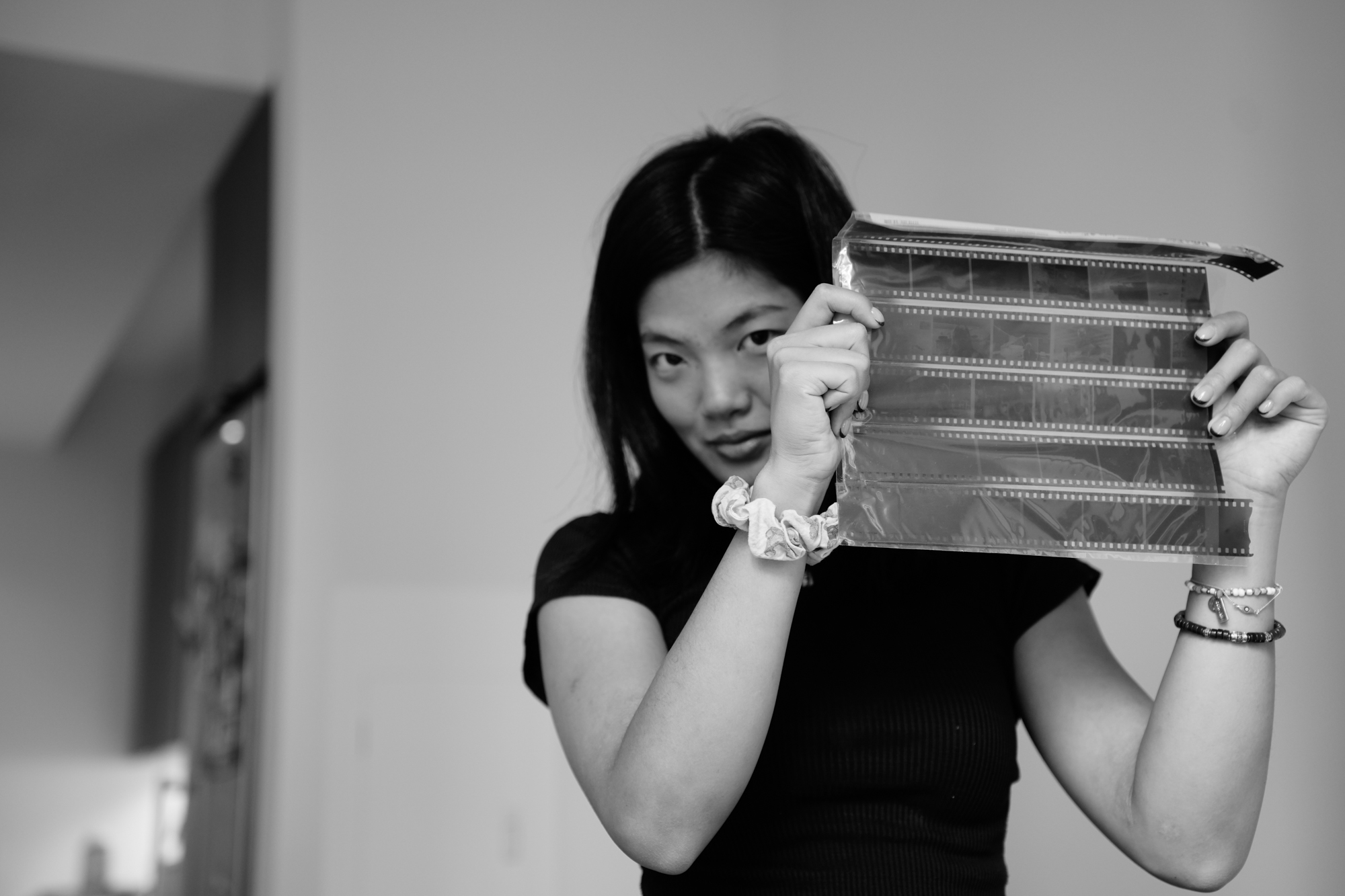 Rachel Zhong displays film negatives she developed in New York. Nov. 22, 2025.