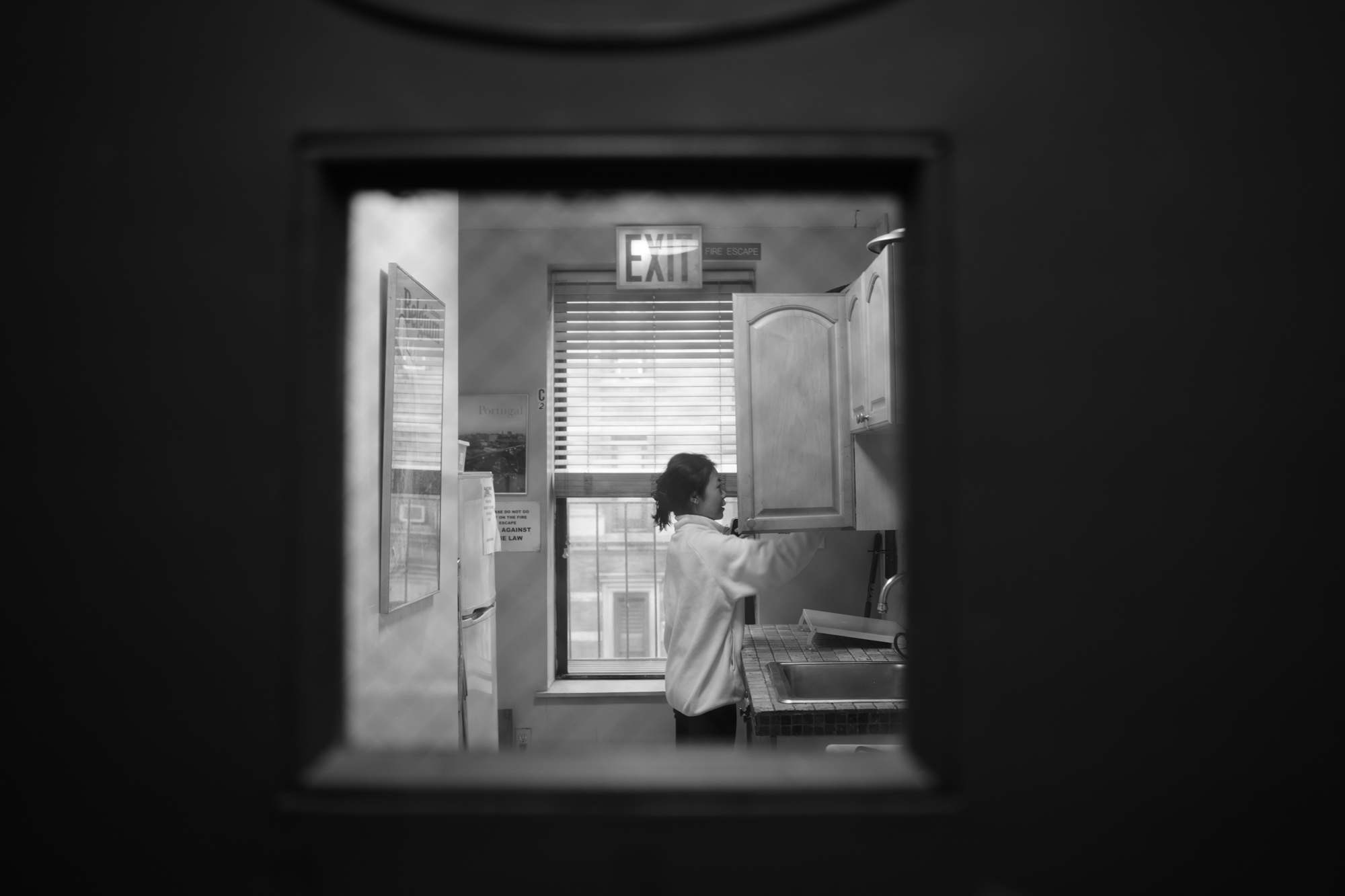 Christine Cheng stands in the laundry room of her apartment building. Nov. 19, 2025.