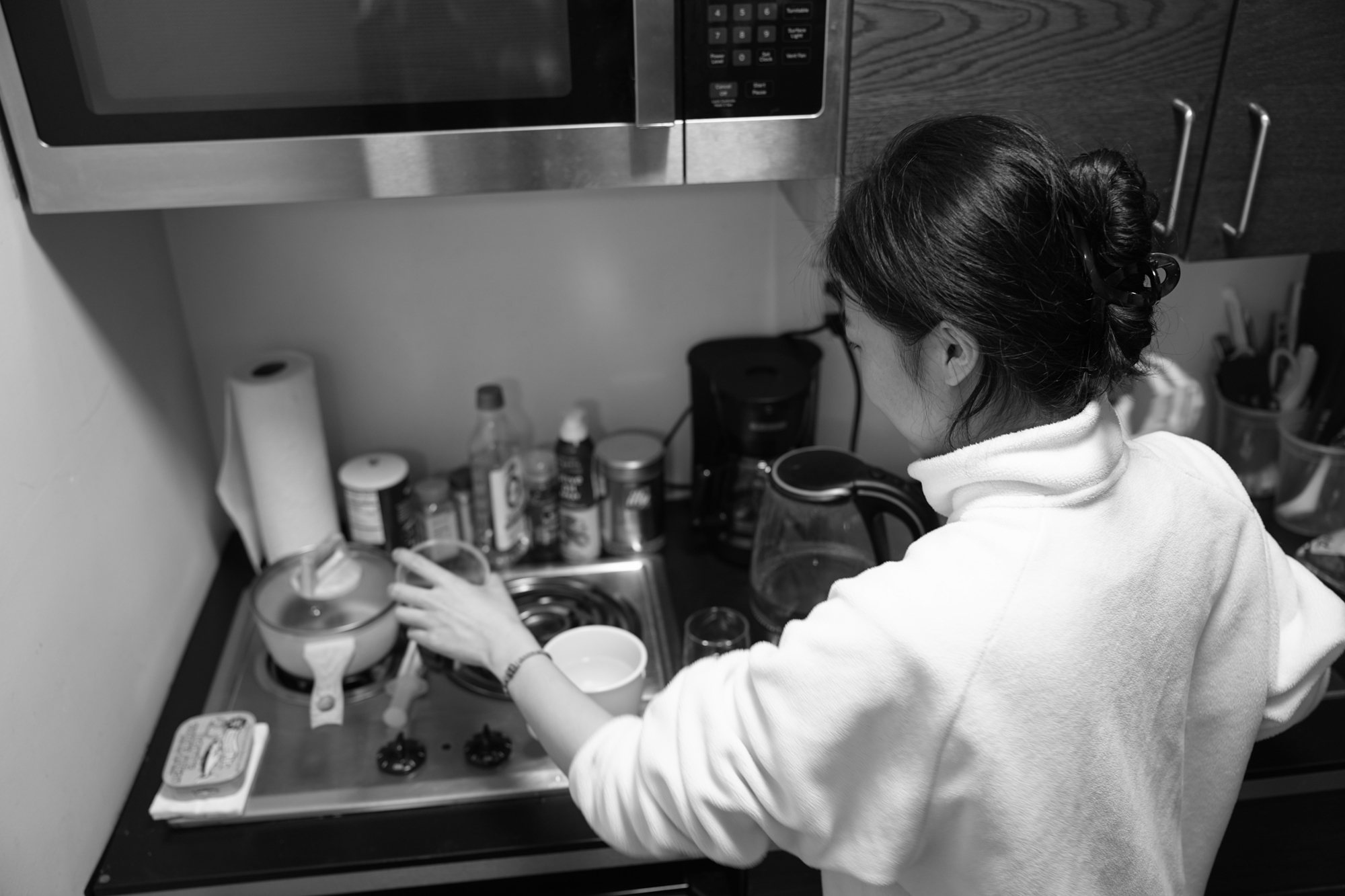 Christine Cheng prepares coffee in her kitchen. Nov. 19, 2025.