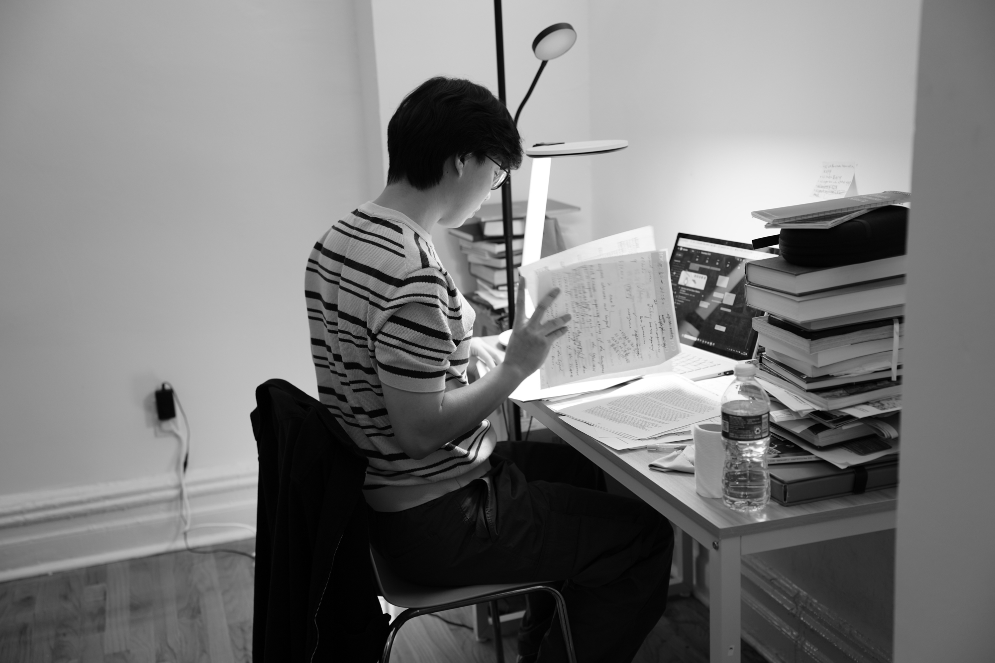 Ziyuan Yin studies at his desk, where journalism and computer-science assignments share the same surface. Nov. 19, 2025.